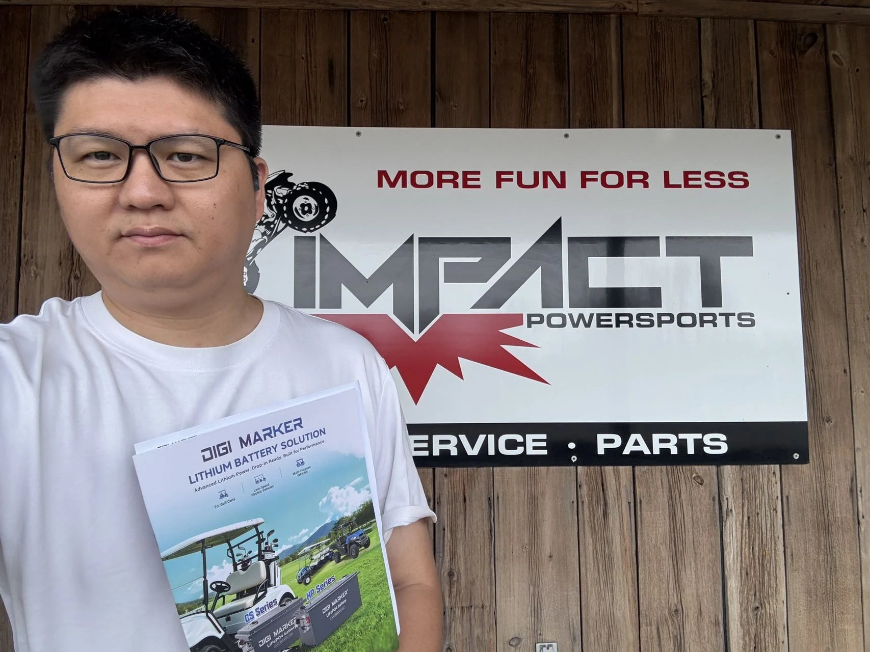 Person holding DigiMarker material during a powersports business visit