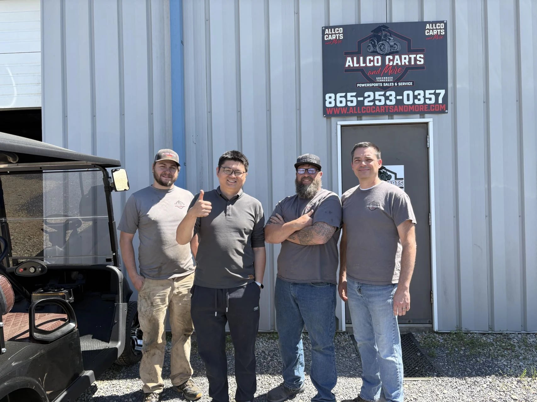 Group gathered during a golf cart business visit